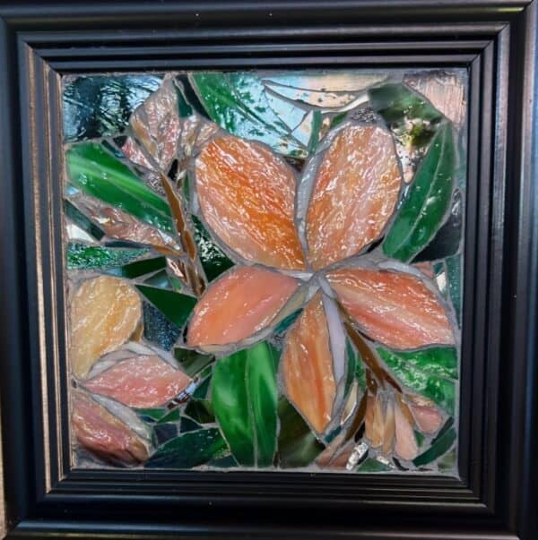 A painting of leaves and flowers in a frame.