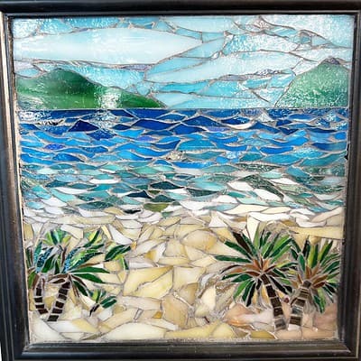 A mosaic of the ocean with palm trees in it.